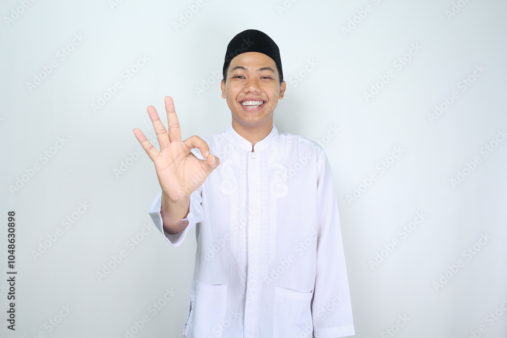 smiling asian man muslim show ok signs isolated on white background smiling asian man muslim show ok signs isolated on white background