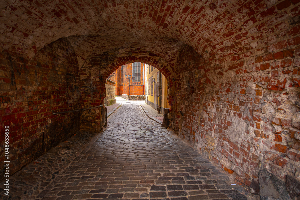 Fototapeta premium Old street in old Riga. The city is capital of Latvia that is well known to be a very popular tourism destination in the Baltic region