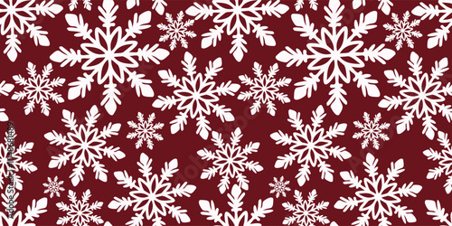 A seamless pattern of hand-drawn snowflakes on a vibrant red background. The snowflakes are intricate and detailed, perfect for a winter-themed design texture. Vector illustration.