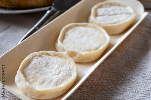 Rocamadour or cabecous soft goat AOC cheese with soft rind produced on farm in Perigord and Quercy on farmers market, departement Lot, France photo