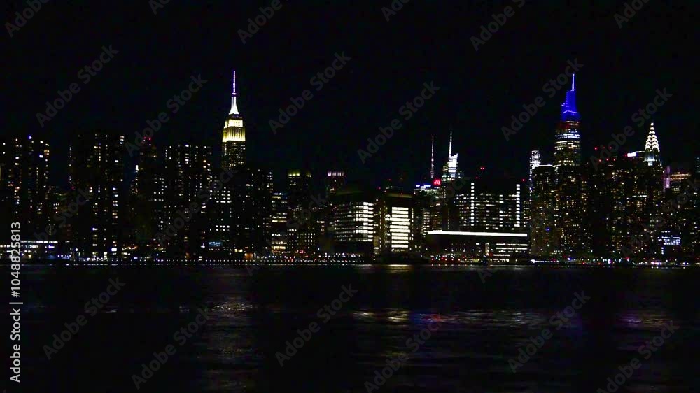 Manhattan skyscrapers seen from the water at night. New York City, USA Manhattan skyscrapers seen from the water at night. New York City, USA