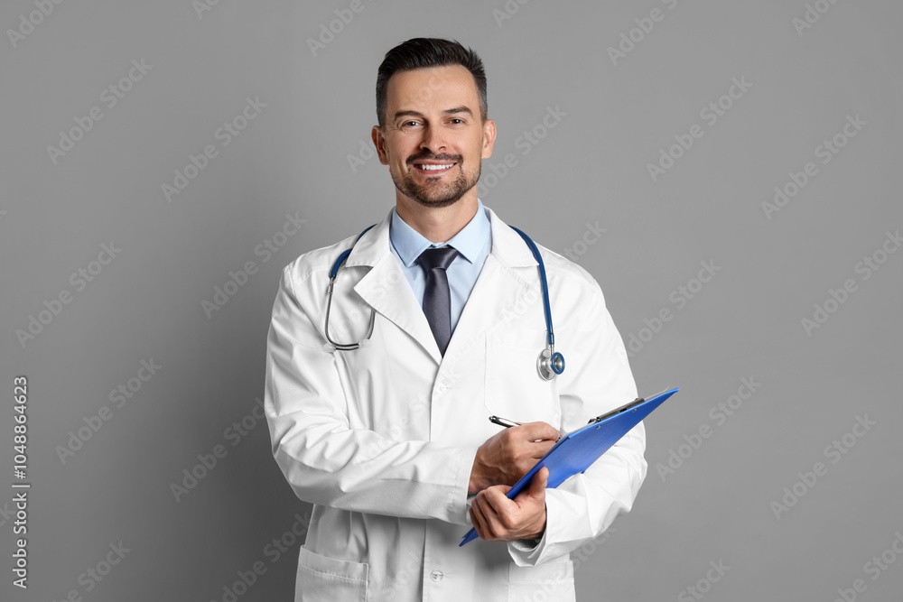 Smiling doctor with stethoscope and clipboard on grey background Smiling doctor with stethoscope and clipboard on grey background