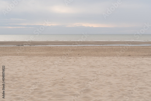 The beach, namely Plage du Touquet, in Le Touquet in France. Cloudy day. Empty beach. Soft focus.