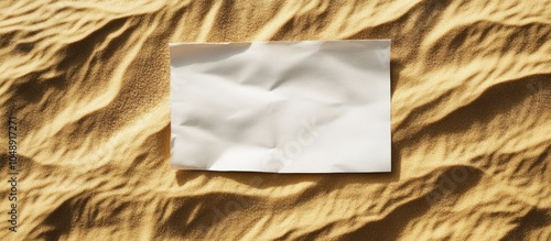 Blank paper on a sandy back...