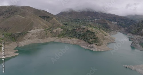 Aerial drone shot wide view over the Canales Reservoir, Embalse de Canales, in the Sierra Nevada mountains in Granada, Andalusia, Spain, Europe. Shot in 5K ProRes 422 HQ