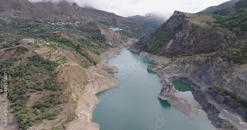 Aerial drone shot wide view over the Canales Reservoir, Embalse de Canales, in the Sierra Nevada mountains in Granada, Andalusia, Spain, Europe. Shot in 5K ProRes 422 HQ