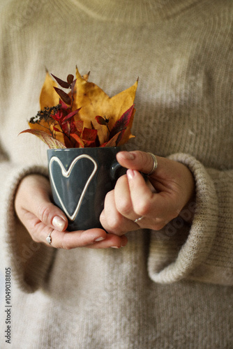 yellow leaves on knitted sweater, lifestyle photos, cozy home, autumn pictures