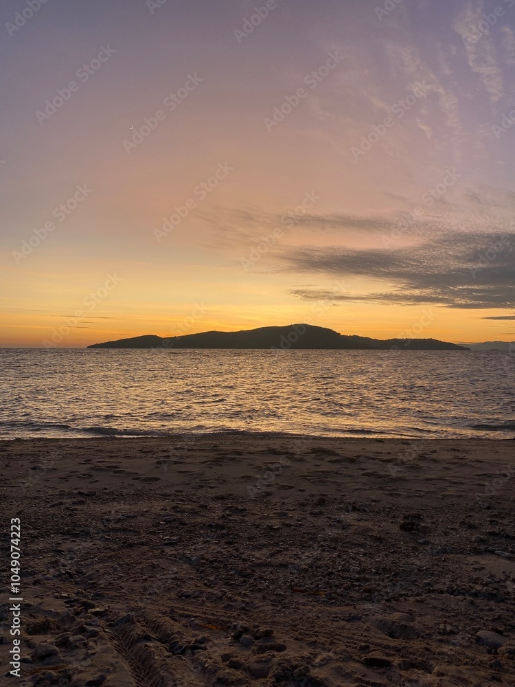 Beautiful sunrise with a view over the ocean and an island, Komodo National Park, Flores, Indonesia Beautiful sunrise with a view over the ocean and an island, Komodo National Park, Flores, Indonesia