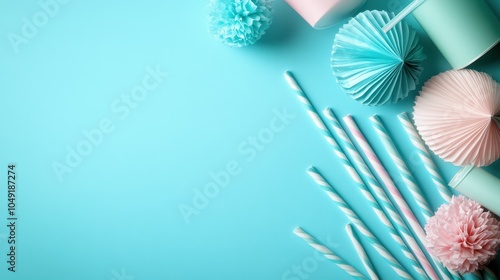 An array of festive paper decorations alongside striped drinking straws displayed on a bright turquoise surface, capturing a sense of joy and celebration. photo