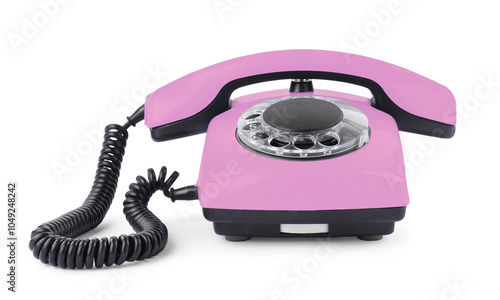 Old pink telephone with rotary dial isolated on white photo