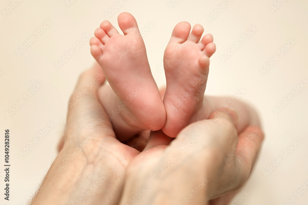 A loving parent cradles a newborn\'s tiny feet in their gentle hands during a tender moment of bonding at home A loving parent cradles a newborn\'s tiny feet in their gentle hands during a tender moment of bonding at home