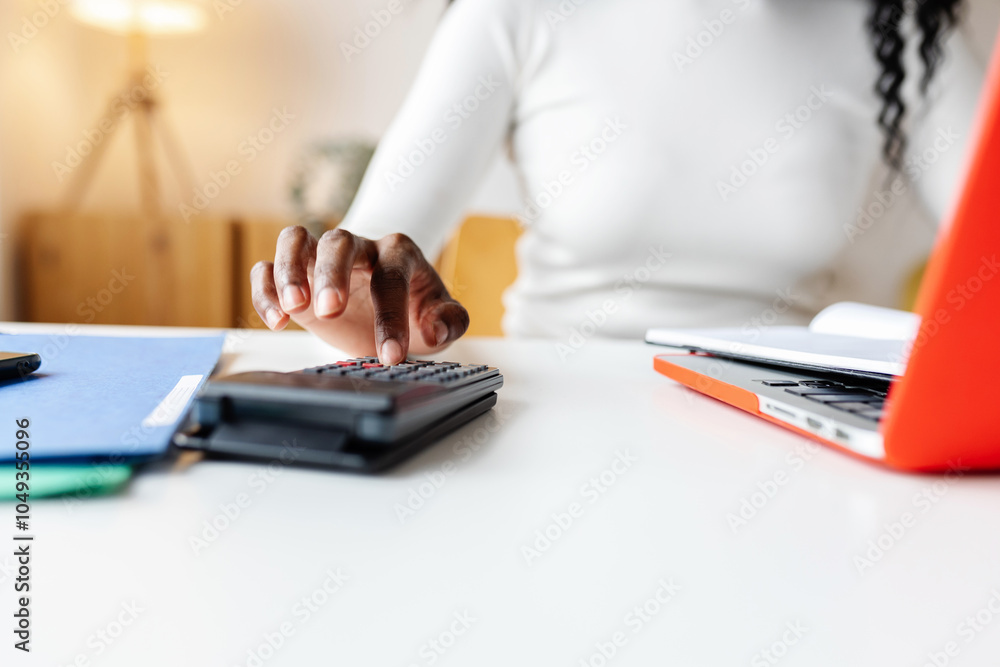 Fototapeta premium Close up of female accountant using calculator working at home office calculating business expenses