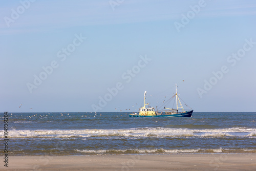 Fotografija Fishery concept, Fishing boat sailing in the sea with net or trawl on the side t