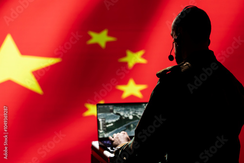 Chinese air defense operator using radar system on laptop to detect intercontinental ballistic missiles. CCP red army soldier scanning rockets approaching borders, isolated over China flag photo