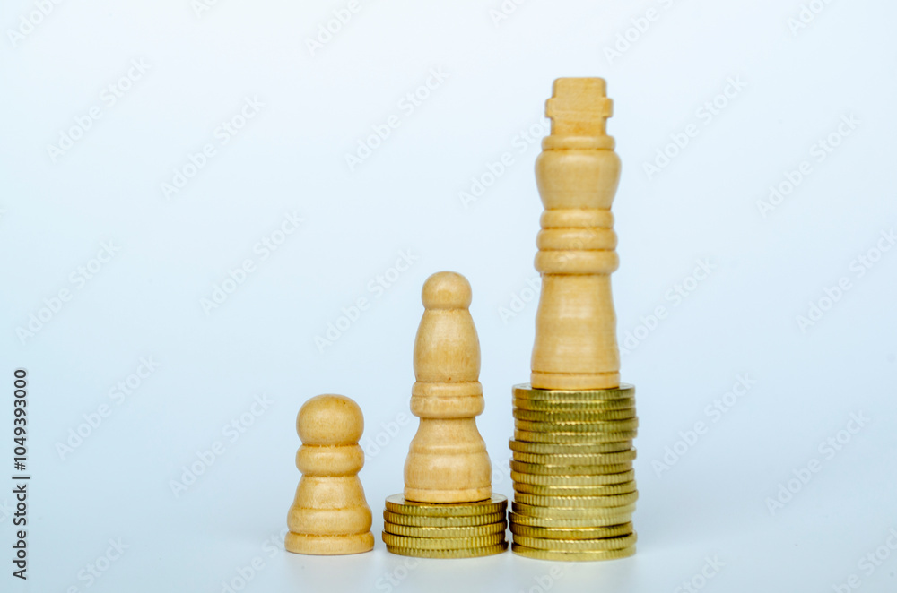 Chess pawns on top of golden stacking coins representing wealth and power Chess pawns on top of golden stacking coins representing wealth and power