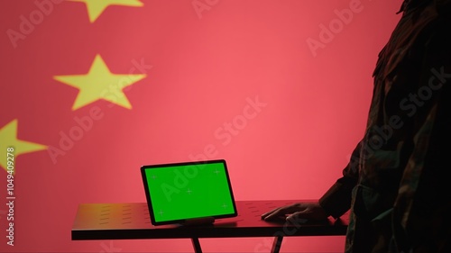 Chinese intelligence agency operator using green screen tablet to do mass propaganda on internet. CCP government secret agent engaging in psychological operations with mockup device, camera A photo