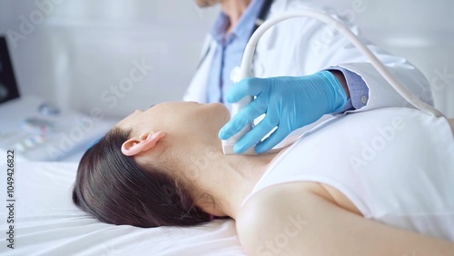 Doctor man wearing blue medical gloves is using ultrasound equipment on neck of female patient lying down for a medical examination