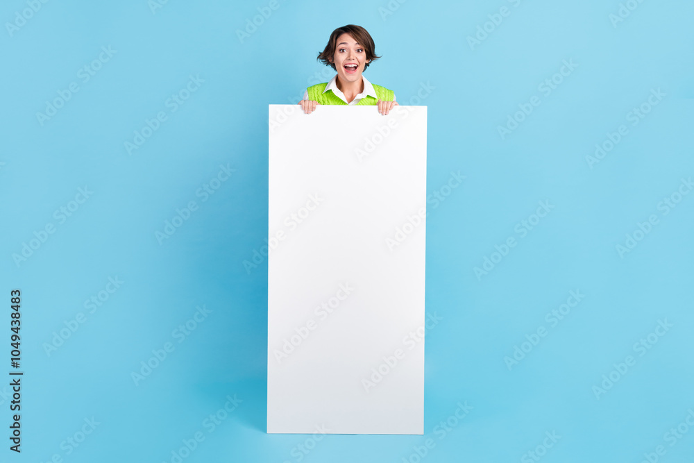 Full length photo of impressed nice woman bob hairstyle green waistcoat presenting smart phone ui menu isolated on blue color background Full length photo of impressed nice woman bob hairstyle green waistcoat presenting smart phone ui menu isolated on blue color background