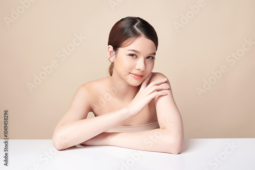 Beautiful young asian woman with clean fresh skin on beige background, Face care, Facial treatment, Cosmetology, beauty and spa, Asian women portrait.