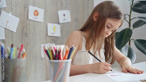 Creative child drawing at the desk at home or school class room