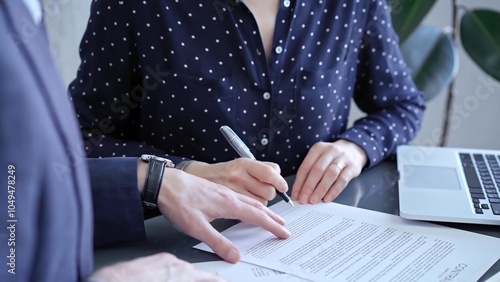 Slika na platnu Detailed view of two business people or lawyers signing a contract with a laptop