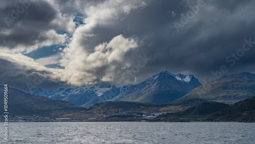 Wallpaper Mural A beautiful mountain range of the Andes. Snow-capped peaks against the sky and clouds. The city of Ushuaia is at the foot, on the ocean. View from the Beagle Canal. Argentina. Patagonia Torontodigital.ca