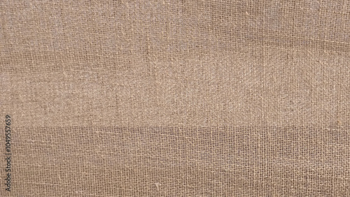 Close-up of fabric woven from burlap. Sack background. Jute texture