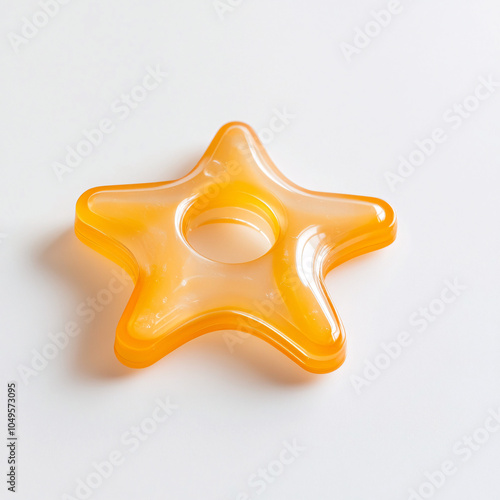 yellow star shaped rubber baby teether on white background photo