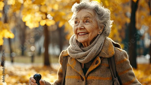 A smiling older woman in her 70s with a walking impairment is seen in a park, leaning on a gimp stick and grasping the knob of a cane. photo