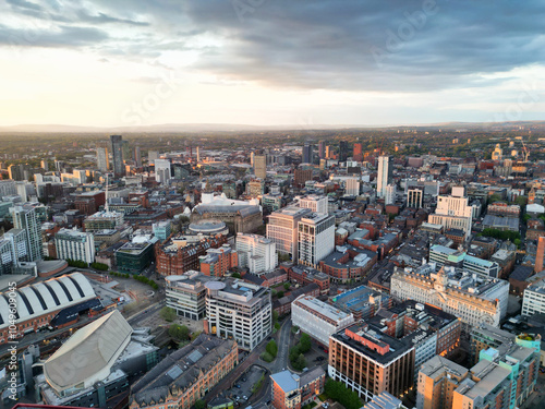 Aerial View of Greater Manchester City Centre and Tall Buildings During Golden Hour of Sunset, England UK. High Angle View Was Captured with Drone's Camera on the day of May 5th, 2024 photo