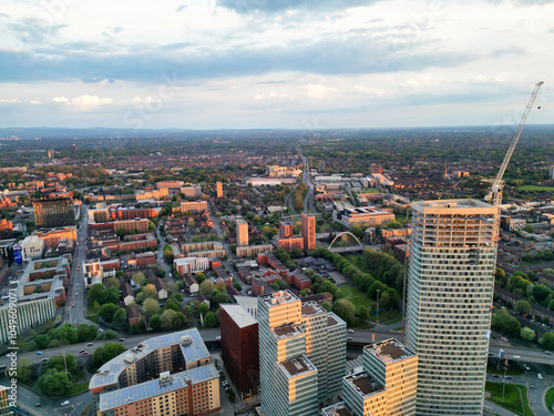 Aerial View of Greater Manchester City Centre and Tall Buildings During Golden Hour of Sunset, England UK. High Angle View Was Captured with Drone's Camera on the day of May 5th, 2024