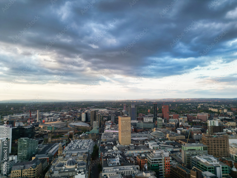 Fototapeta premium Aerial View of Greater Manchester City Centre and Tall Buildings During Golden Hour of Sunset, England UK. High Angle View Was Captured with Drone's Camera on the day of May 5th, 2024