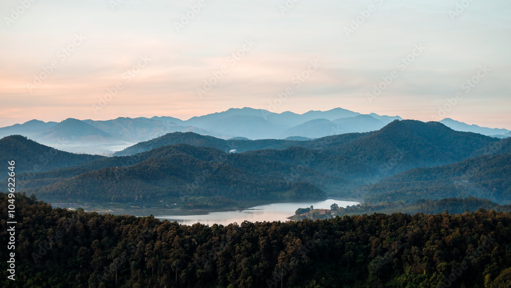 Obraz premium Overlapping mountain landscape in the morning with clouds and fog on the mountain surface.