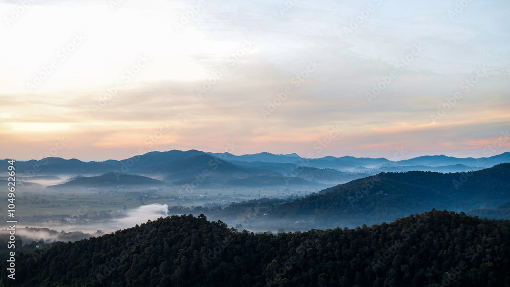 Fototapeta premium Overlapping mountain landscape in the morning with clouds and fog on the mountain surface.