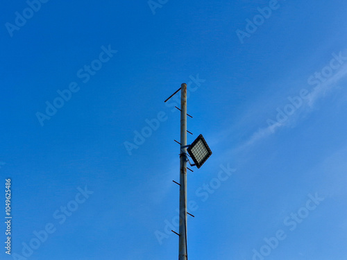 Pole for beach lighting with a bright blue sky background