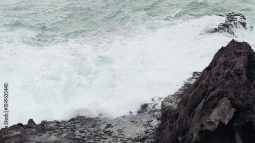 Wave breaking against the rocks at Jusangjeollidae, Jeju-do Island, South Korea photo