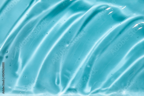 Liquid gel beauty serum texture. Beauty skincare liquid blue gel background with bubbles. Skincare hygiene product closeup.	