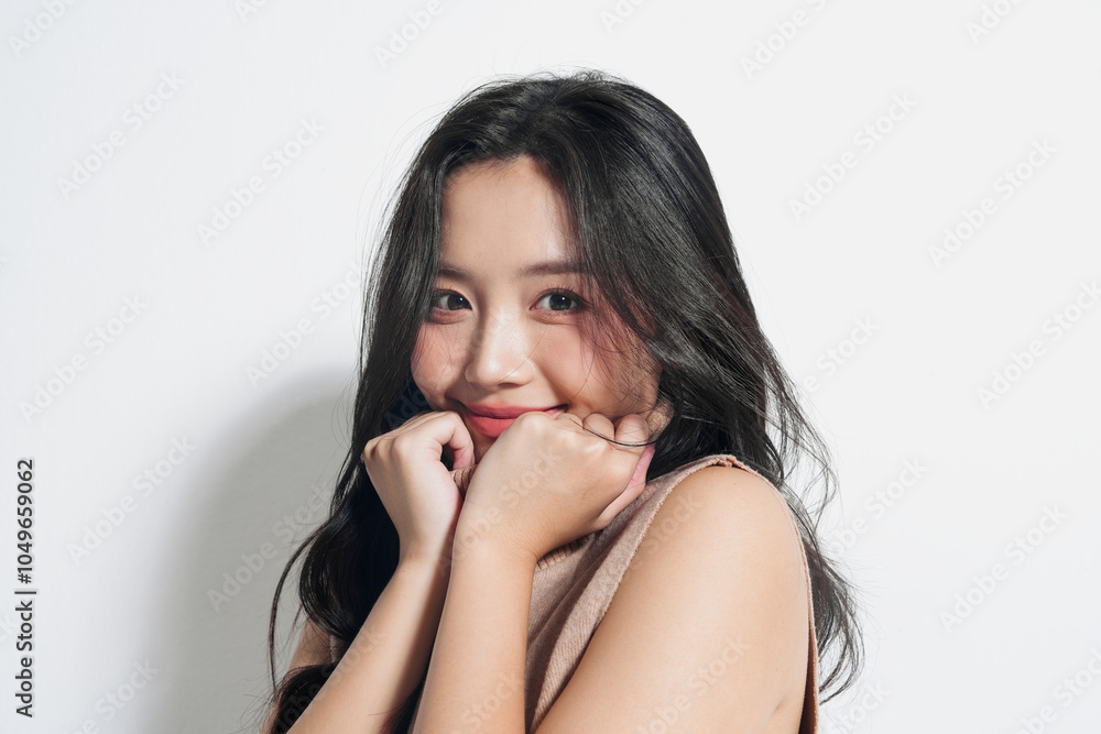 Naklejka premium 白背景で撮影をしたセーターを着た若い女性のスタイリッシュなポートレート