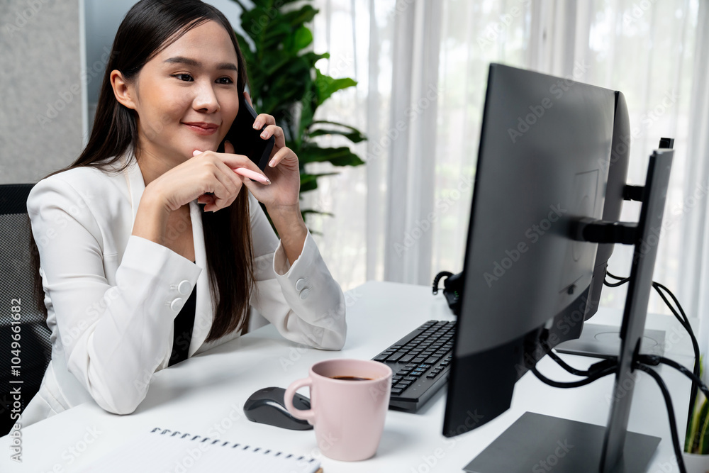 Working young Asian businesswoman calling to customer to present marketing online strategy advertisements analysis service to analyze on social website for planning channel sales target. Stratagem. Working young Asian businesswoman calling to customer to present marketing online strategy advertisements analysis service to analyze on social website for planning channel sales target. Stratagem.
