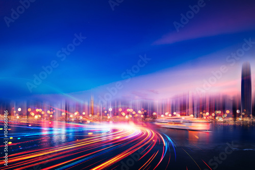 A city skyline at night with blurred light trails streaking through the foreground.