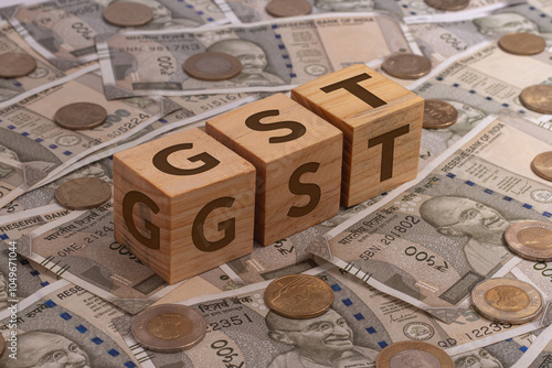 GST Word on Wooden Cubes with Indian Currency and Coins | Financial Investment Concept