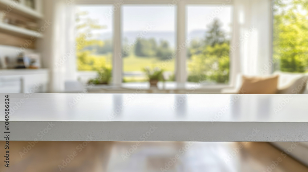 Fototapeta premium Blurred interior of stylish modern kitchen with massive straight white table for display.