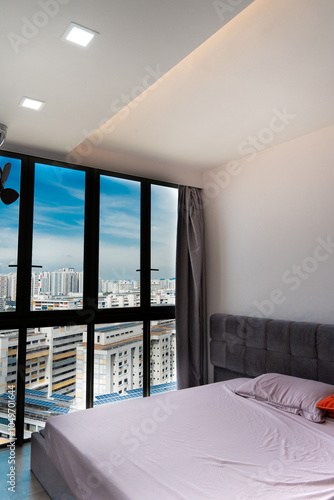 Wall Mural A luxy home master bed room interior with building and sky through the window