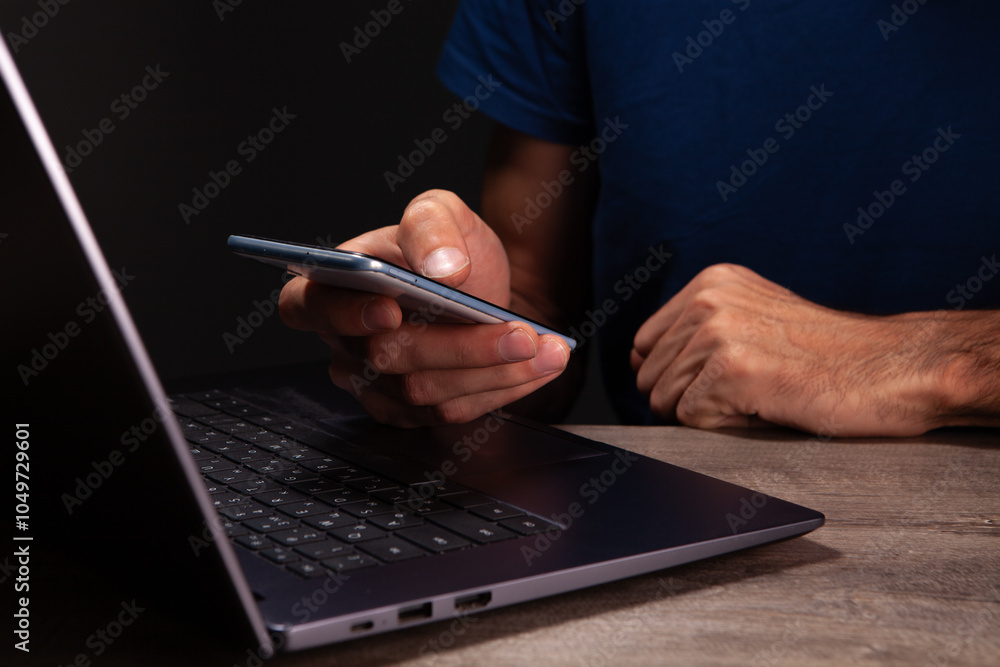 Fototapeta premium shirt works in a modern office. the man is typing on a laptop