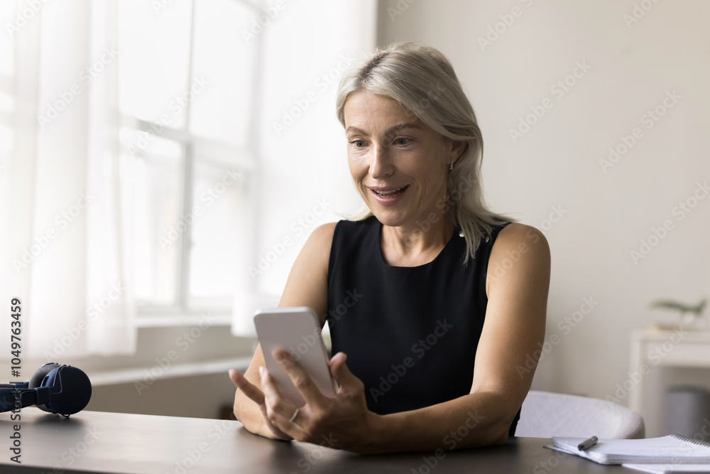 Amazed older age woman work study from home sit at desk look on phone screen receive perfect commercial proposition win online course for free. Excited old female get super present from famous blogger Amazed older age woman work study from home sit at desk look on phone screen receive perfect commercial proposition win online course for free. Excited old female get super present from famous blogger