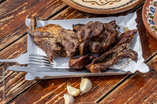 Traditional meniu with mutton pastrami on a wooden table. photo