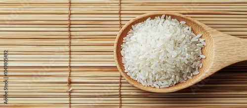 Raw rice in a wooden spoon ...