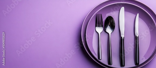 Cutlery on a purple backdro...