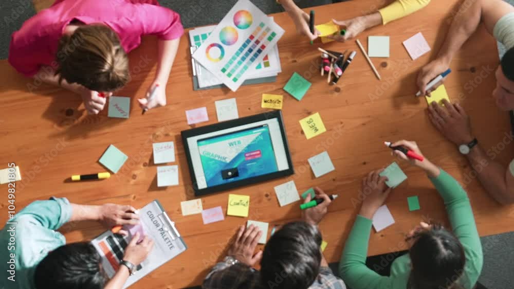 Time lapse of smart business people working together to design web design. Aerial view of designer brainstorming and discussing about website interface for computer or digital application. Symposium.