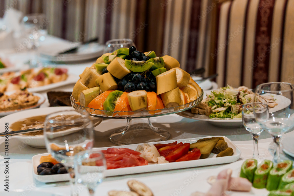 Vibrant Fruit Platter Surrounded by Appetizing Dishes on Elegant Dining Table Vibrant Fruit Platter Surrounded by Appetizing Dishes on Elegant Dining Table